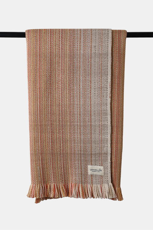 Apricot-toned Alchi wool throw with natural woven texture