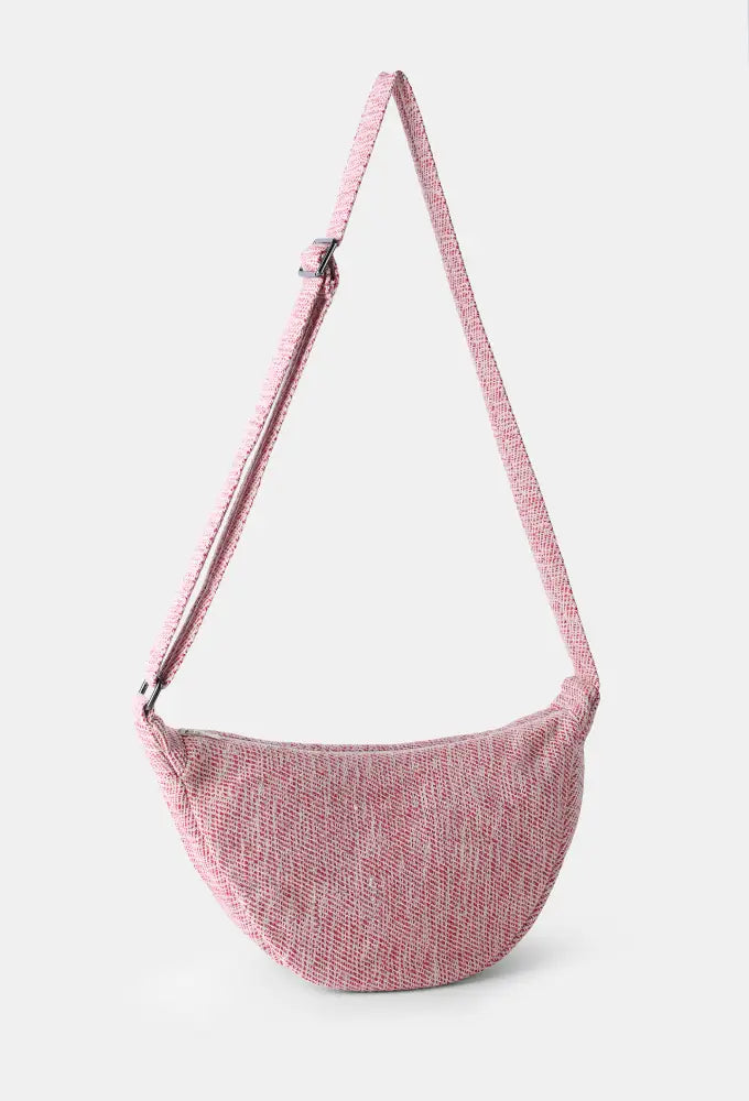 Lac Crossbody Bag showcasing handwoven wool and natural pink weave