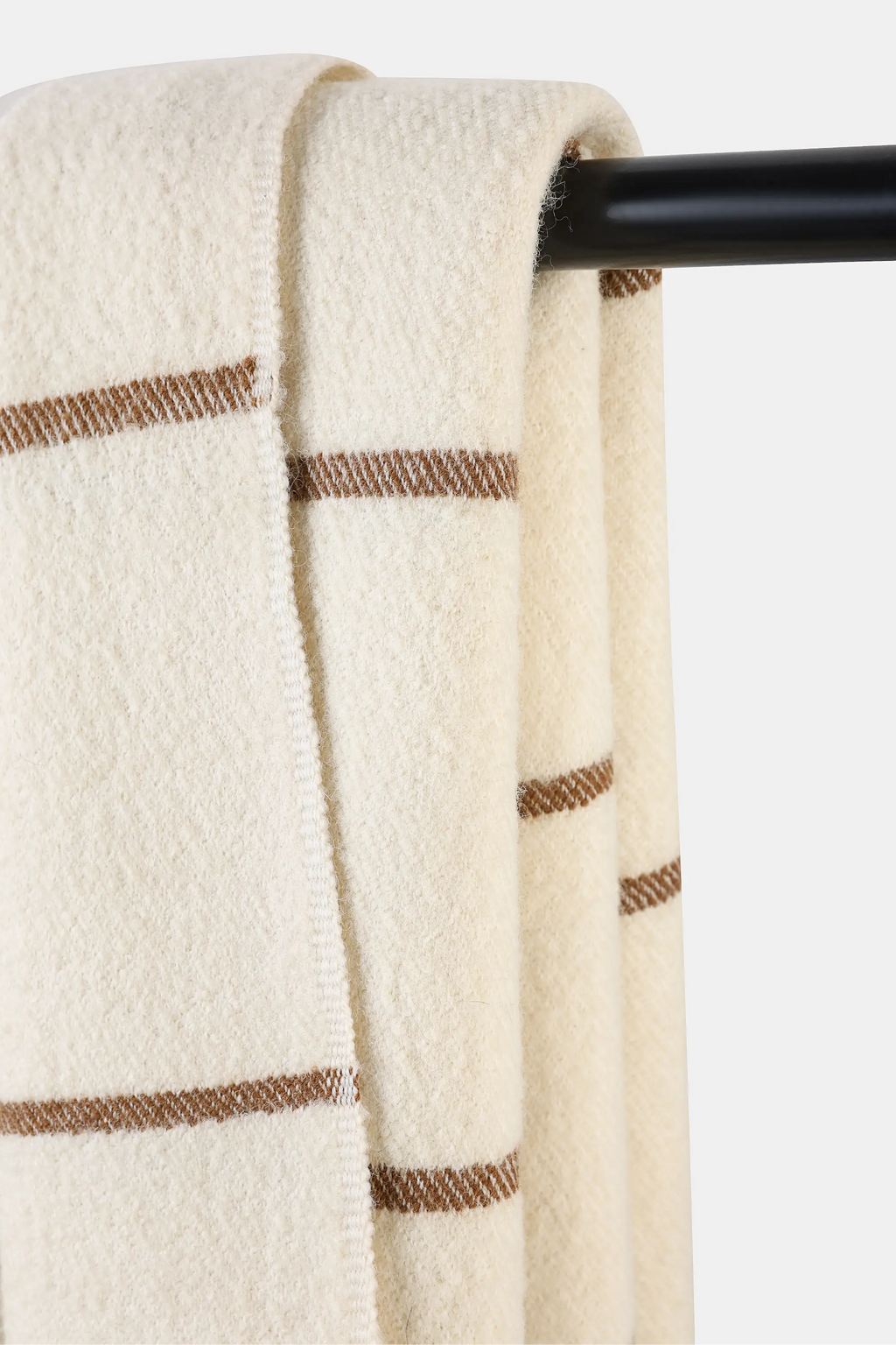 Woven Nubra Dunes Wool Throw in natural white wool with walnut-dyed stripe detailing and fringed edges
