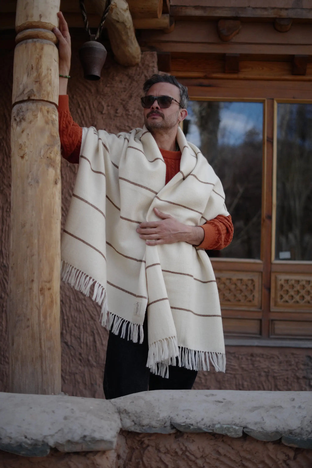 Natural white Nubra Dunes Wool Throw with walnut stripe detailing and fringed edges