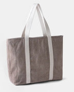Ri Travel Bag showcasing natural undyed and walnut husk–dyed wool weave