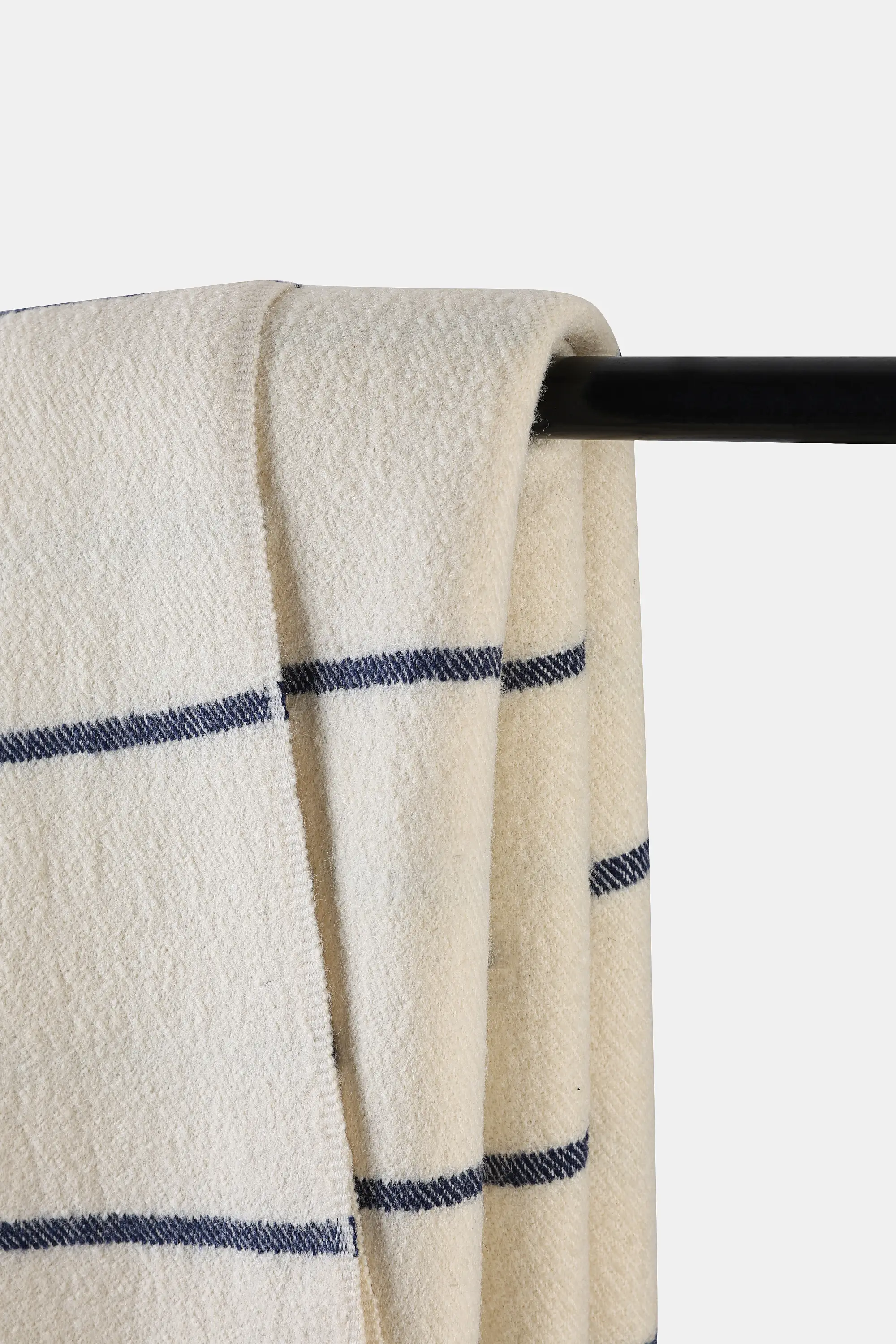 Woven ivory Shey Sunset Throw with delicate blue stripes